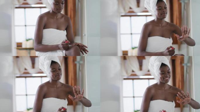非裔美国迷人的女人在浴室修指甲