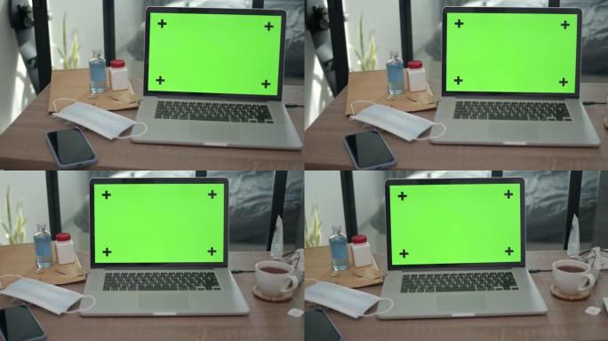 绿屏电脑笔记本电脑的平移镜头，没有人