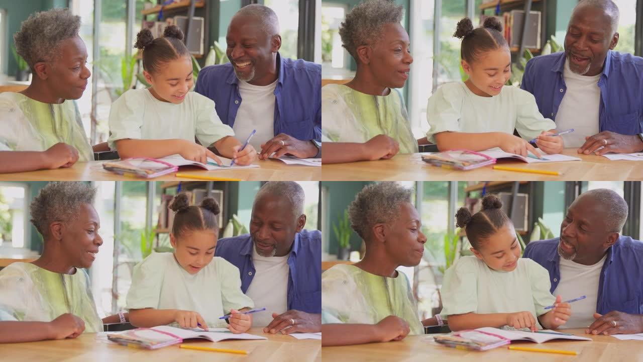 多代家庭与祖父母一起帮助孙女在家做作业-慢动作拍摄