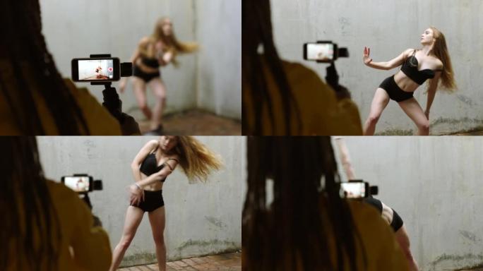 女性有影响力的舞者在直播中跳舞，这是一部为社交媒体网络和在线平台制作视频内容的手机。5g技术非常适合