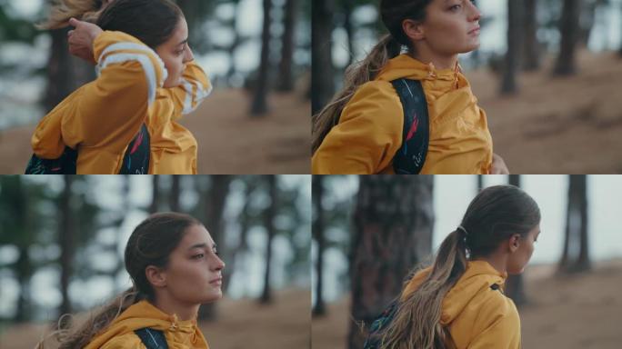 4k视频片段，一名妇女在森林中徒步旅行时绑住头发
