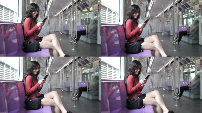 亚洲妇女在火车上使用智能手机