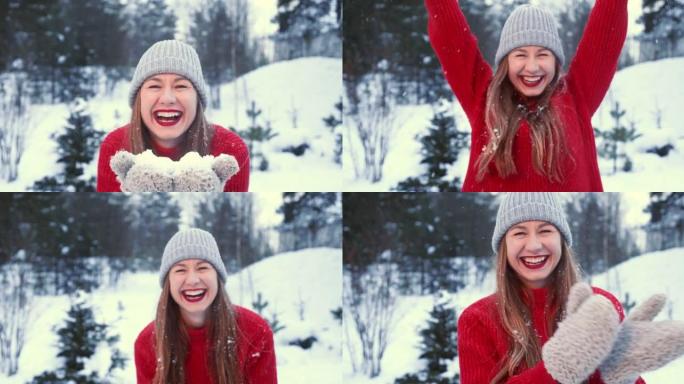 冬天的心情。穿着红色毛衣的美丽年轻有趣的幸福女人在森林慢动作的镜头前穿着手套在雪地上吹