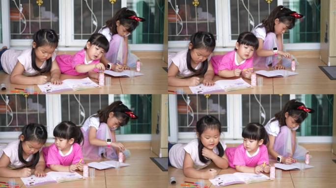 三个小女孩在家画画学习