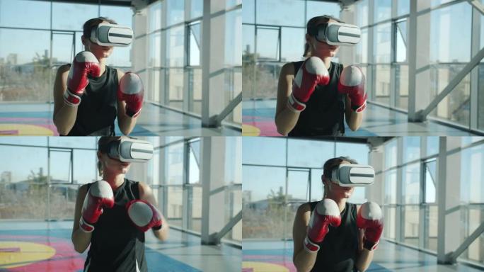 年轻女子在现代健身房训练虚拟现实眼镜和拳击手套