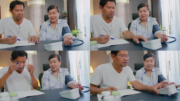 亚洲高级丈夫在家测量妻子血压。健康问题