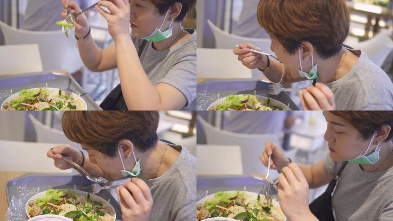 吃米粉的亚洲女人吃饭时蔬健康饮食