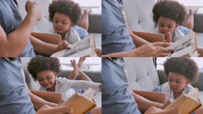 非洲父亲的家庭正在读书，而小男孩的儿子则通过笔记本电脑从家里学习在线课程。模拟图书阅读器