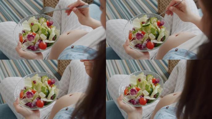 孕妇在家里享用美味蔬菜沙拉的特写镜头