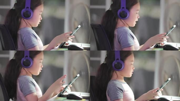 可爱的小女孩和她的朋友在平板电脑上玩网络游戏