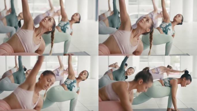 妇女在健身工作室的健身课上练习瑜伽。在小组训练期间，多样化且专注的活跃女性伸展和弯曲以执行姿势和体式