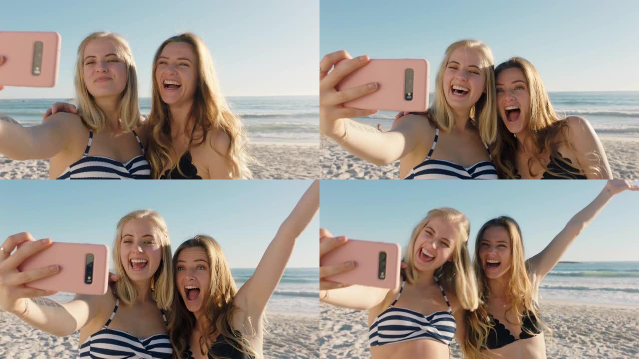 女朋友在海滩上用智能手机自拍，享受暑假，享受海边的夏天