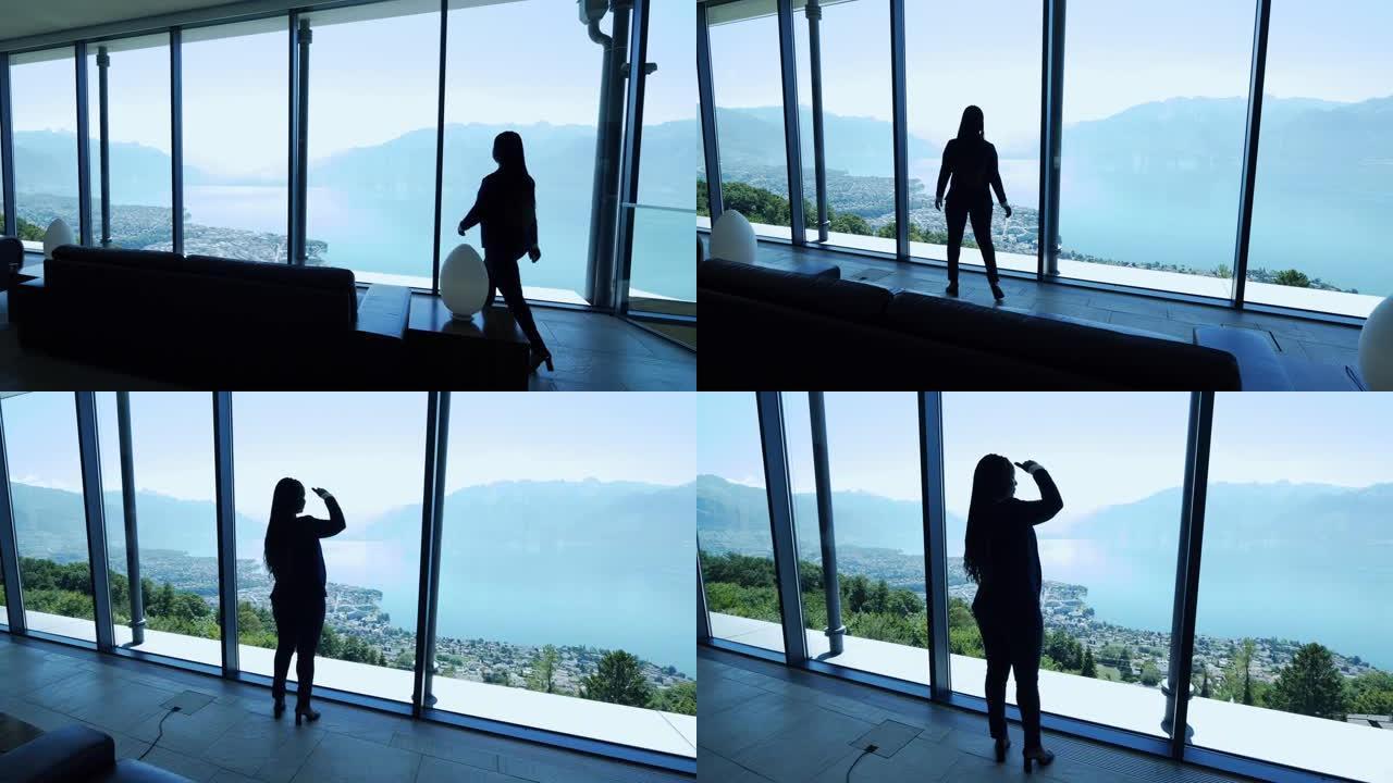 现代未来建筑内的女性商人俯瞰湖泊城市全景窗口视图