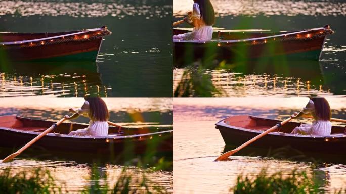 慢动作年轻女子在装饰的船上，灯光漂浮在湖上