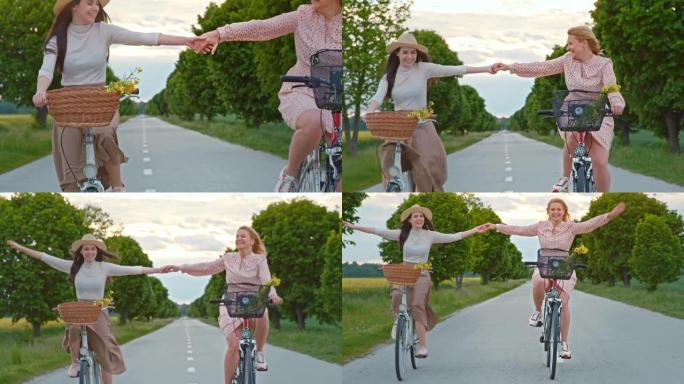 慢动作女性朋友骑自行车时玩得开心