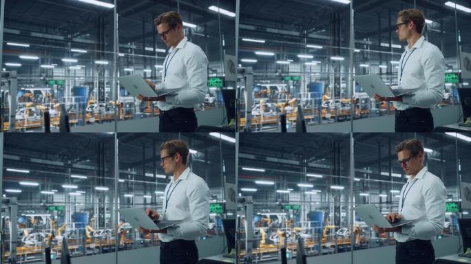 穿着眼镜和白衬衫的英俊工程师使用笔记本电脑，在汽车装配厂的办公室里望去。在技术设施中从事车辆设计的工