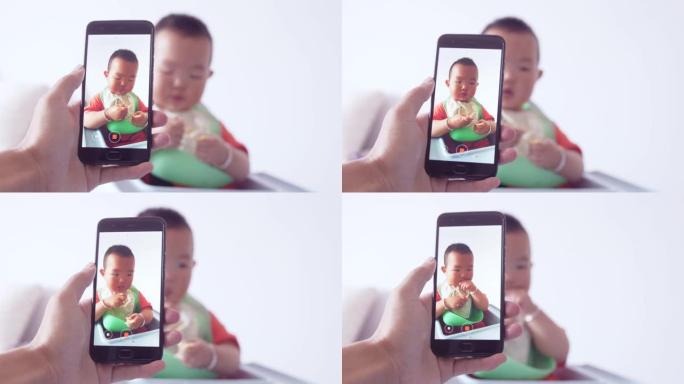 拍摄男婴用手机吃食物