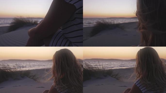 日落时海滩上一个金发女孩的慢动作视图。