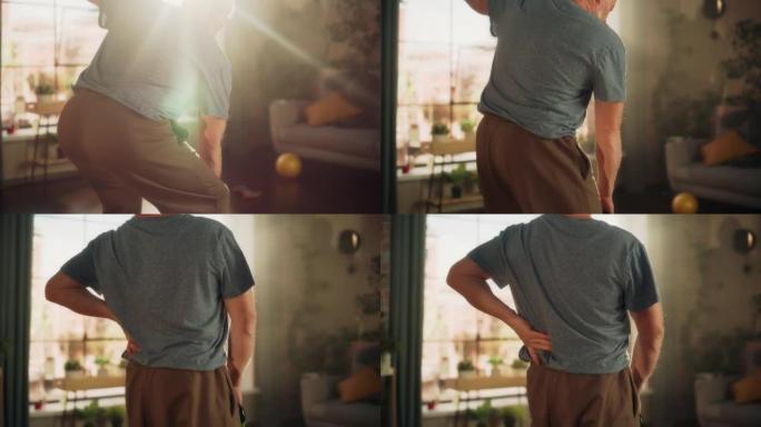 老年人在早上锻炼时会感到不舒服，突然背痛，而在家中则要负重锻炼。中年男性抓住他的背来减轻疼痛。