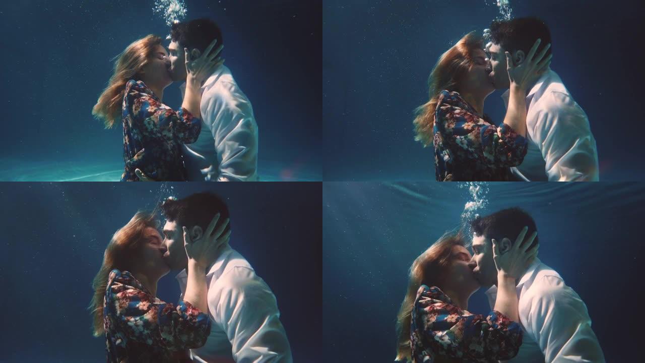 年轻无忧无虑的浪漫情侣的电影拍摄是在他们的蜜月假期期间在blu水下激情接吻。爱情、关系、自由、性感、