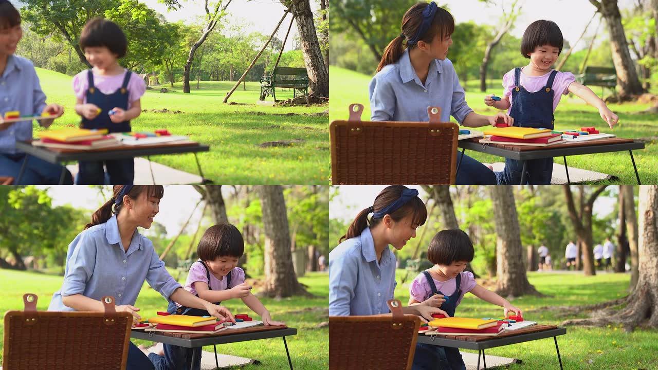 一个小女孩和她的母亲在公园里一起学习或玩耍，充满爱与温暖，或者在教室外学习，由单身母亲自学