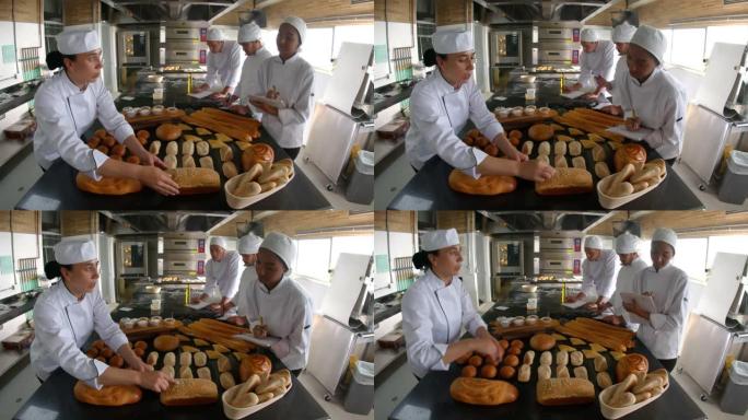 成年妇女在做笔记时向不同的学生传授不同类型的面包