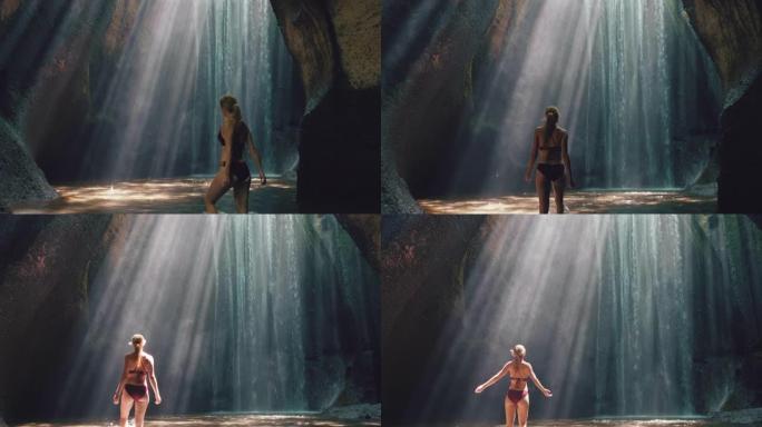 瀑布洞里的美女穿着比基尼独自探索地下洞穴，水溅起光线