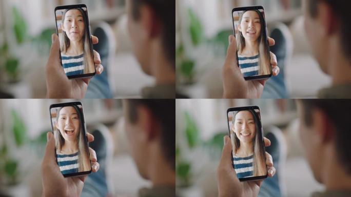 年轻人用智能手机视频聊天，在屏幕上与女朋友聊天，享受手机上的对话分享生活方式长途关系垂直方向4k