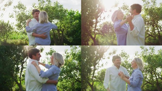 可爱的快乐成熟夫妇的真实特写镜头是享受时间在一起，并在绿色自然的背景下跳舞庆祝他们永恒的爱。