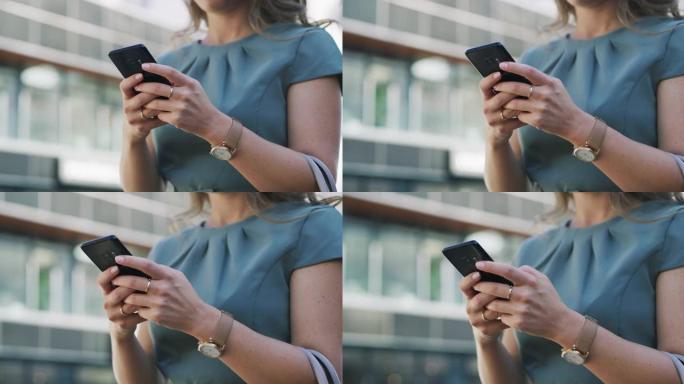 在城市中使用智能手机的一名无法识别的女商人的4k视频片段