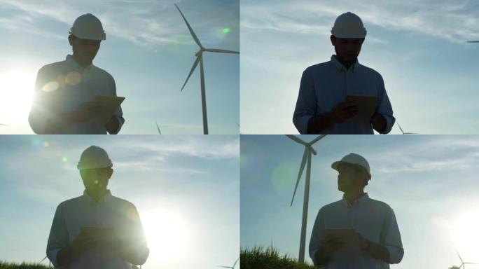 在风力发电站工作的年轻男工程师的剪影日落，检查风车农场的能源生产。可再生能源工厂概念。