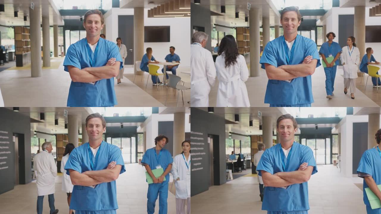 男医生穿着磨砂膏折叠双臂站在繁忙的医院的肖像