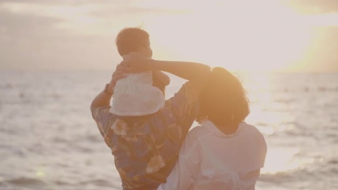 亚洲家庭在日落时带着快乐的情感在沙滩上奔跑。家庭、度假和旅行