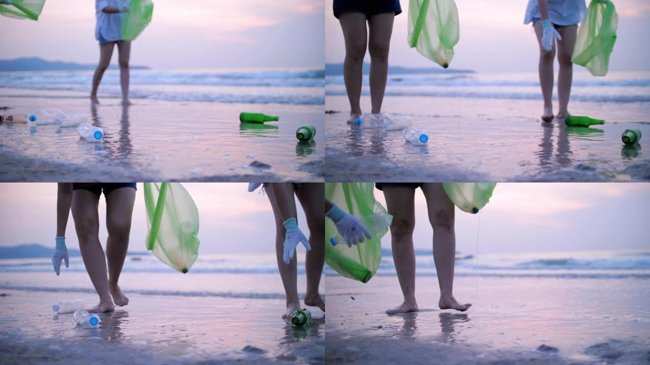 一群年轻女子在海滩上捡塑料瓶，回收概念