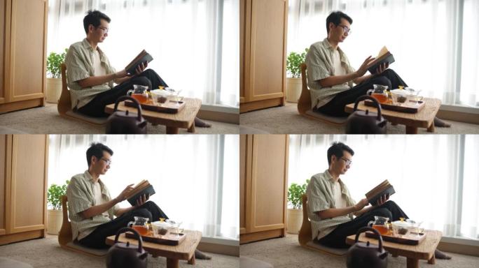 亚洲男子在家看书女人在家喝中国茶倒茶笔记