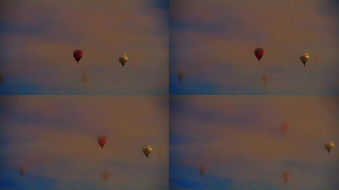 在宁静的天空中漂浮在空灵的云层中的热气球