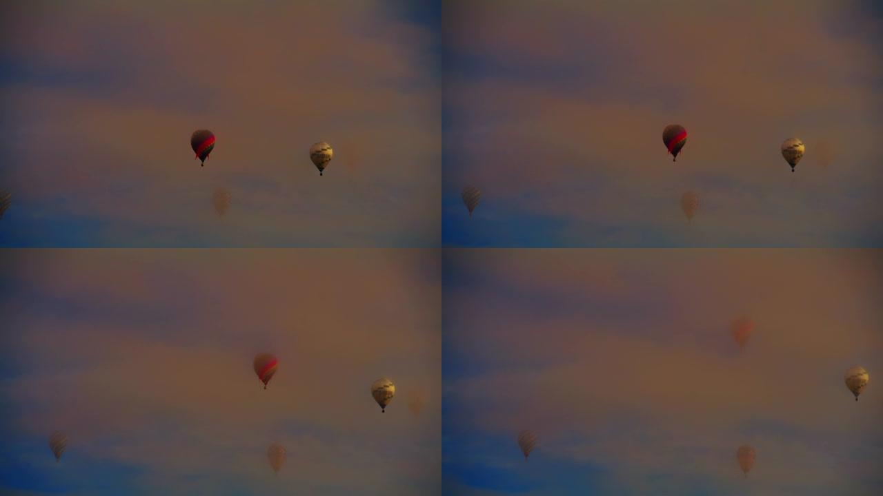 在宁静的天空中漂浮在空灵的云层中的热气球