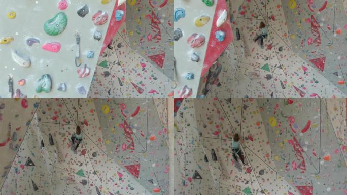 空中: 运动少年带领在攀岩健身房攀登具有挑战性的路线