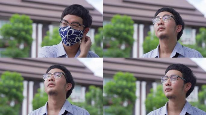 在锁定/检疫期间，亚洲男子第一次戴口罩后呼吸新鲜空气