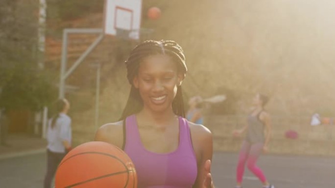 非裔美国女子篮球运动员持球看相机肖像