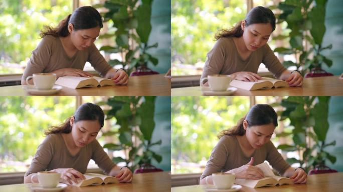 亚洲女性在咖啡店读书