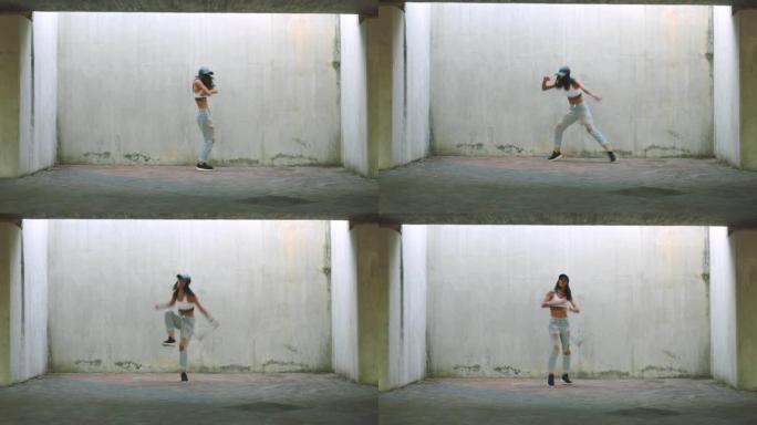 女人，城市舞蹈和嘻哈街头艺术家在澳大利亚户外城市墙壁背景上的能量，自由和才华表演。年轻女孩，舞者文化