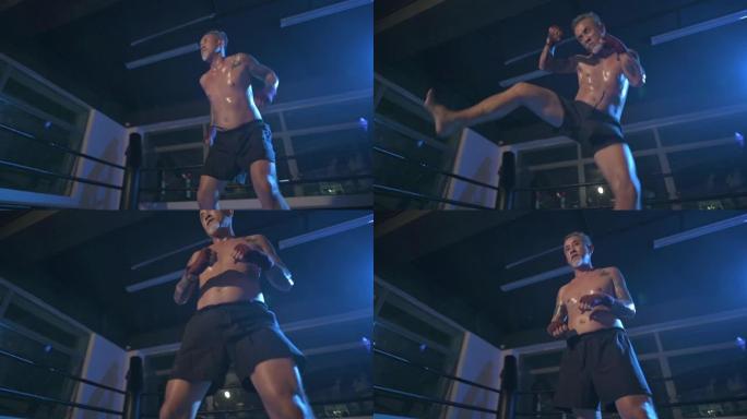 慢动作亚洲华裔高级男子夜间在体育馆拳击场上跳脚