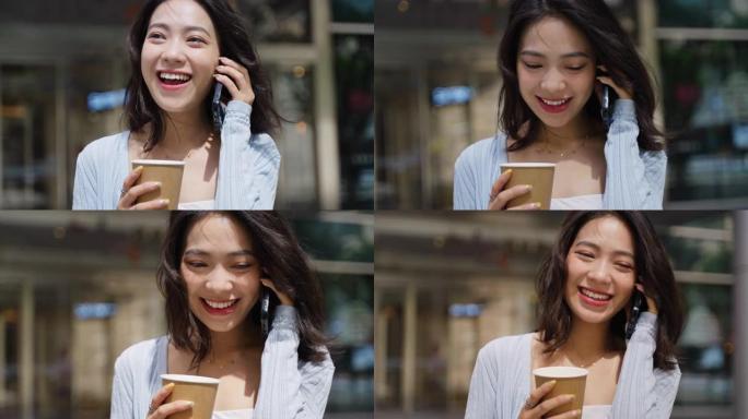 迷人的年轻亚洲商务女士走在城市街头用手机聊天放松快乐办公室女士在城市慢动作