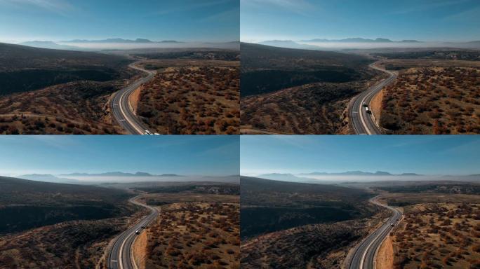 山路蜿蜒，蓝天映衬。运输的概念。无人机录像。