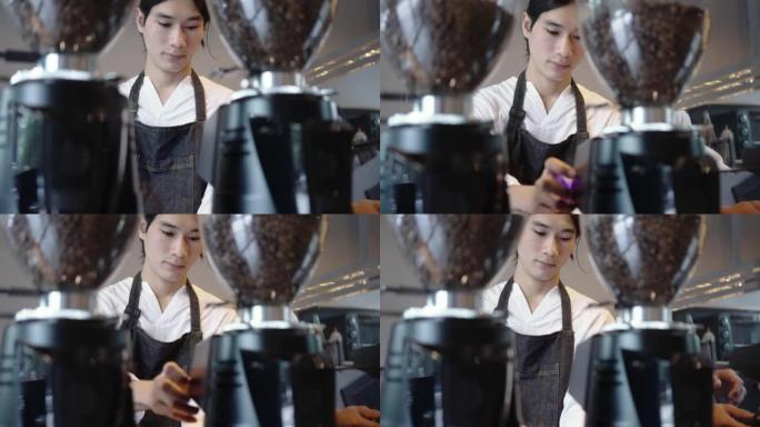 男士咖啡师与咖啡机械一起工作，以压实咖啡粉，在咖啡馆煮咖啡