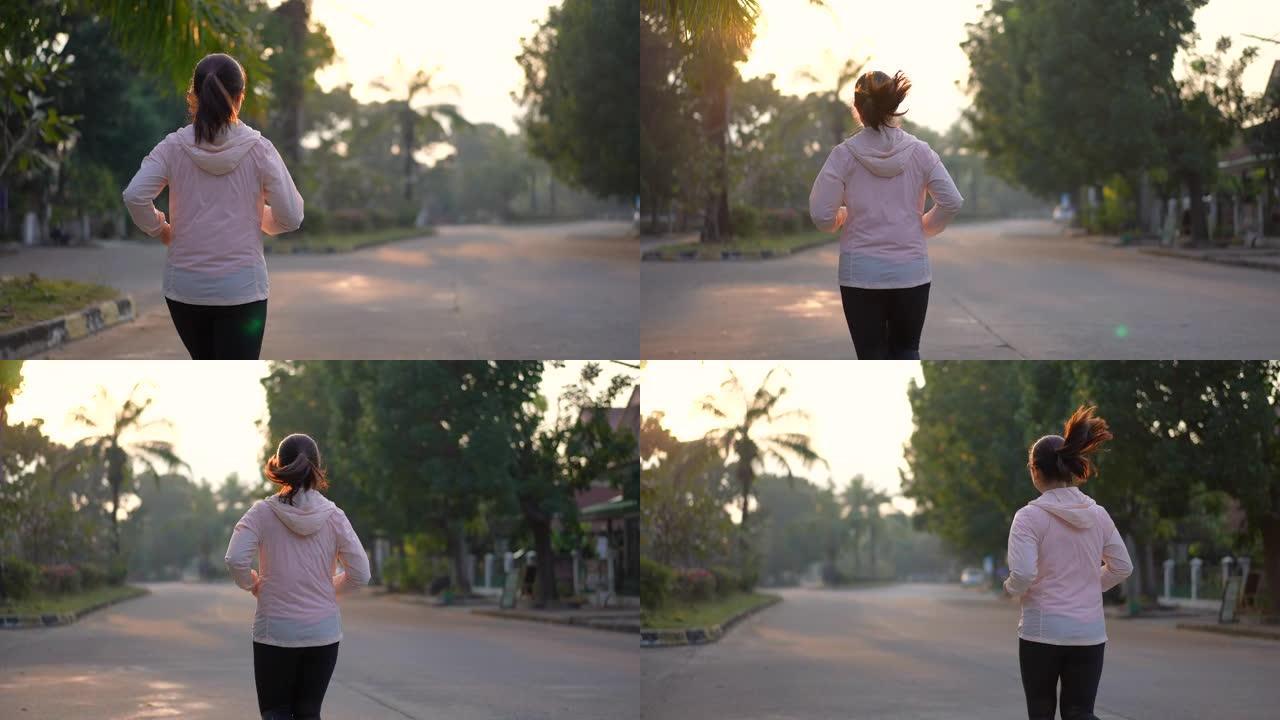 女人早上在村庄公园跑步，运动和健康观念