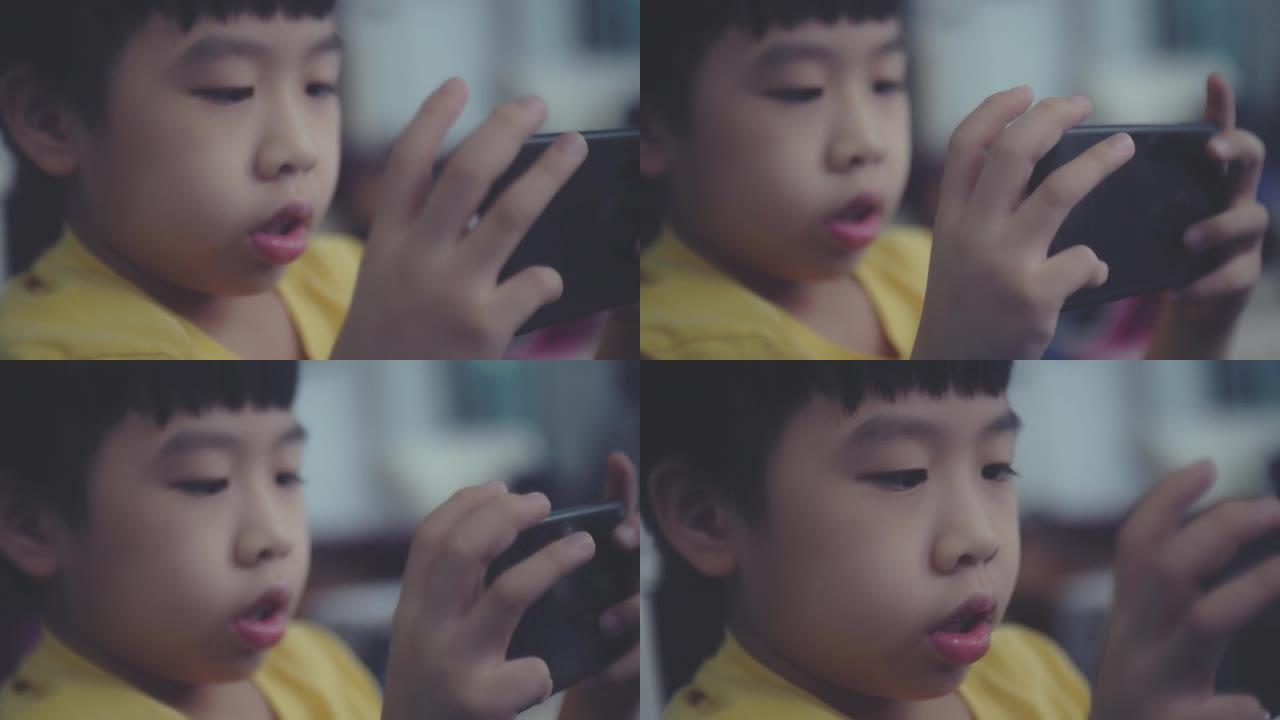 日本男孩小孩玩手机看手机回消息