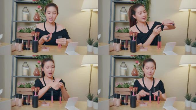 亚洲女性影响者录音教程化妆课显示口红颜色在手上。