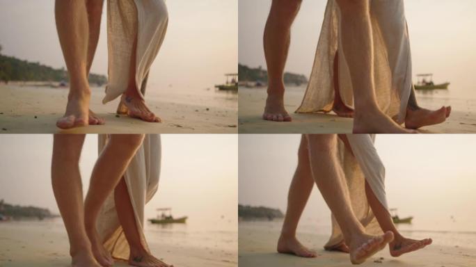 日落漫步中的夫妇脚赤脚沙滩